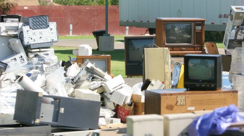Workers wearing PPE and sorting waste for collection
