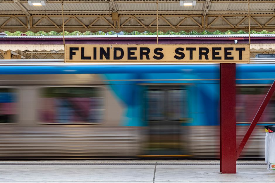 A large historic building with intricate stonework and decorative architectural elements, bearing the sign 'Southern Railway' at the top, serves as an entrance archway. The facade features multiple wi